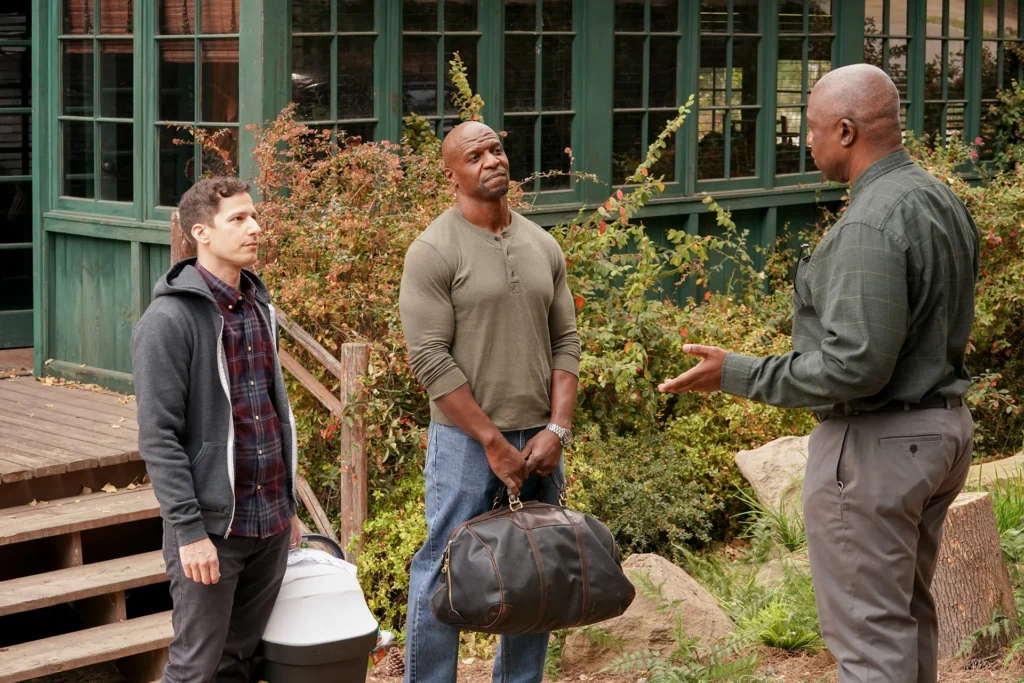 "Detectives from Brooklyn Nine-Nine standing in precinct hallway smiling and laughing"