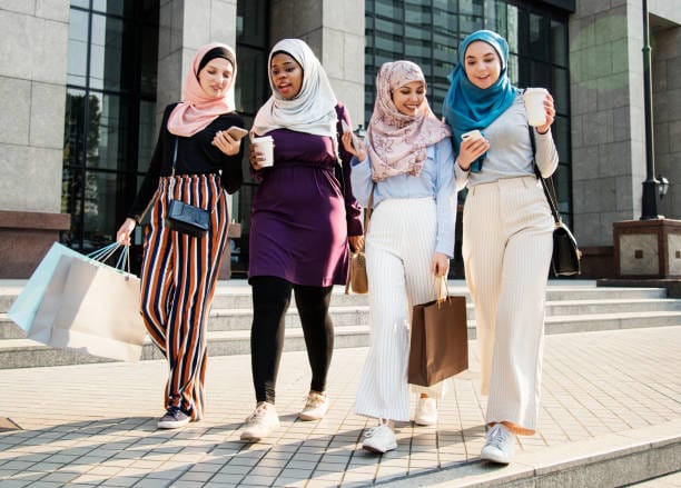 Confident group of women in colorful modest outfits.