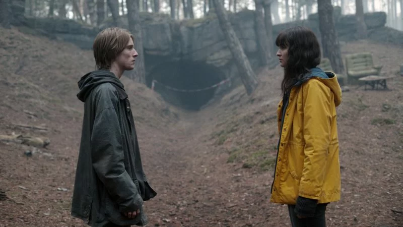 "Moody forest with fog and an eerie clock symbolizing the time travel mystery in Dark"