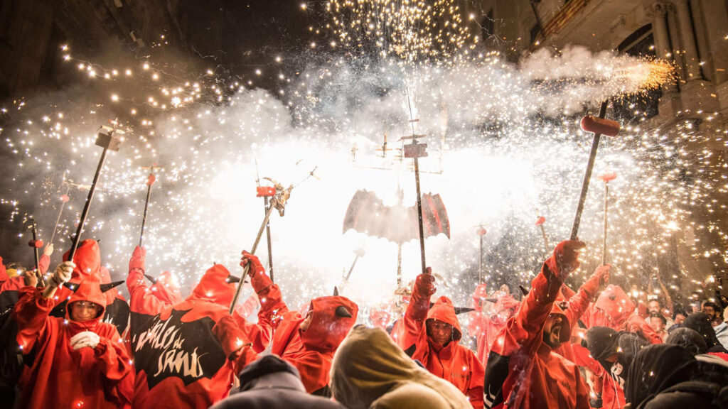 Human towers and fire runs lighting up the streets during La Mercè Festival in Barcelona.