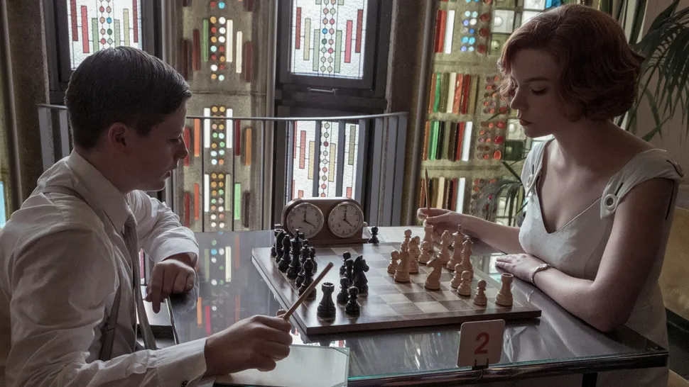 "Beth Harmon intensely focused on a chessboard during a tournament match"