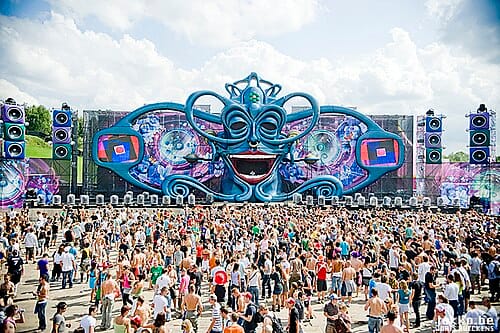 Colorful stage and fireworks display at Tomorrowland electronic music festival in Belgium.