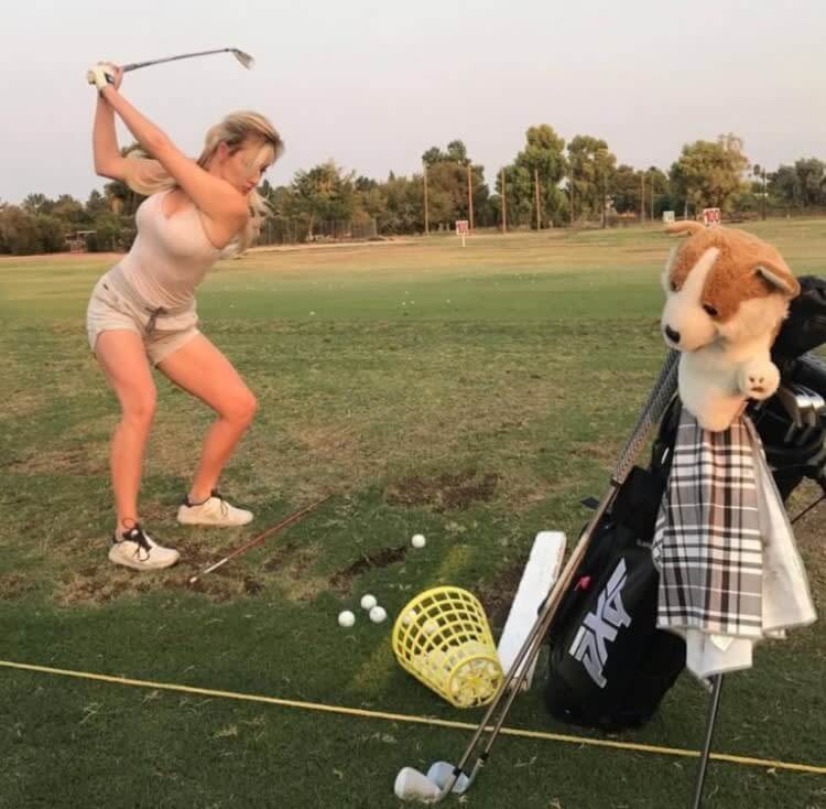 Teenage Paige Spiranac holding a golf trophy after winning a junior golf tournament.