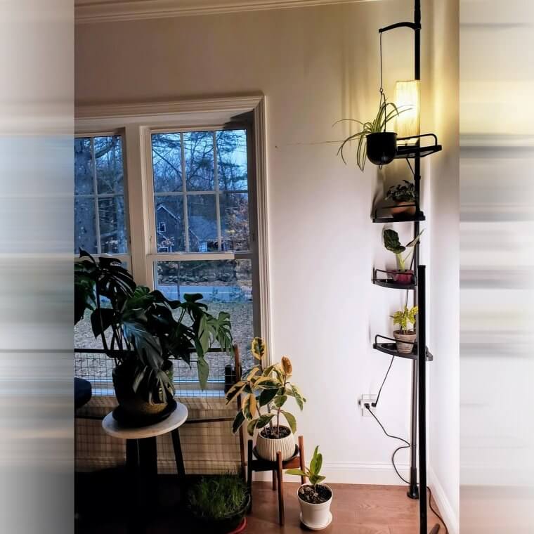 Tension rod standing upright with repurposed dishes or containers stacked and used to hold trinkets or small household items.
