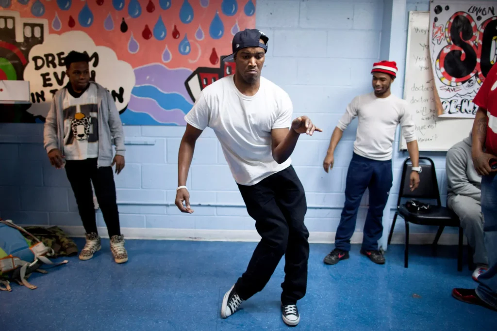 “Group of people dancing wildly during the Harlem Shake meme trend inspired by Baauer’s hit song.”