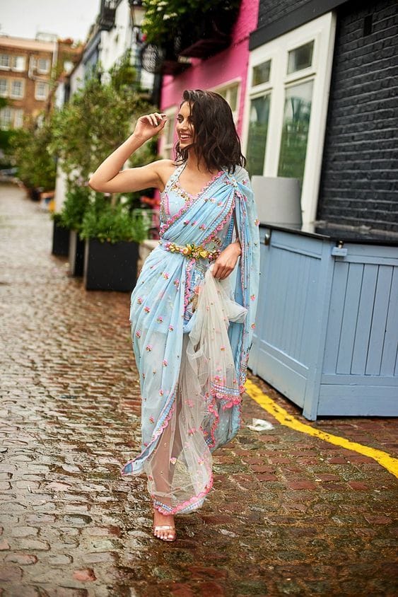 Fashionable woman in a sari cinched with an ornate belt, enhancing her waistline, styled for a formal event.