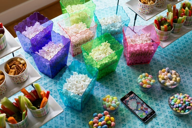 “DIY decorations and homemade snacks on a budget for a themed movie night party.”