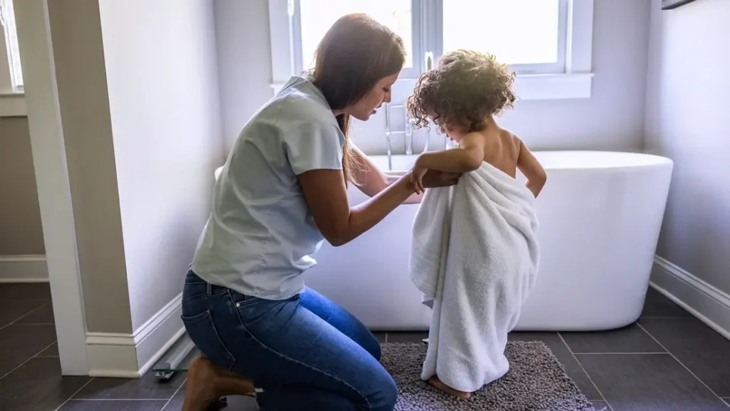 “Soft cotton robe and clean towels stacked in a serene bathroom setting.”