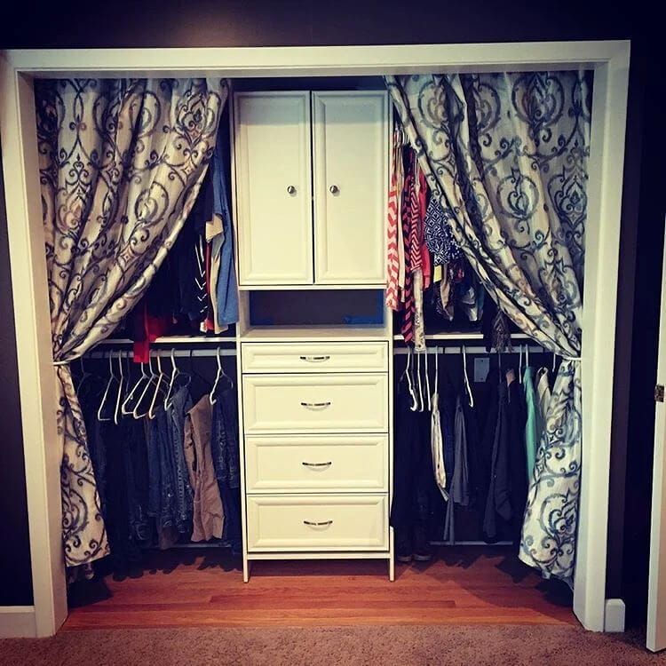 Closet space with curtains hung on a tension rod in place of traditional doors, saving space and adding a decorative touch.