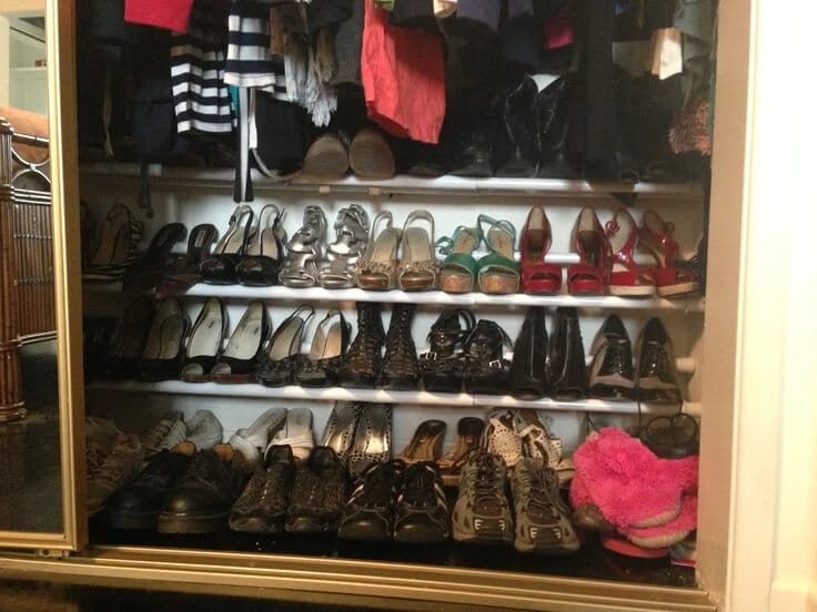 Closet floor with multiple horizontal tension rods stacked to hold pairs of shoes in an organized, space-saving arrangement.