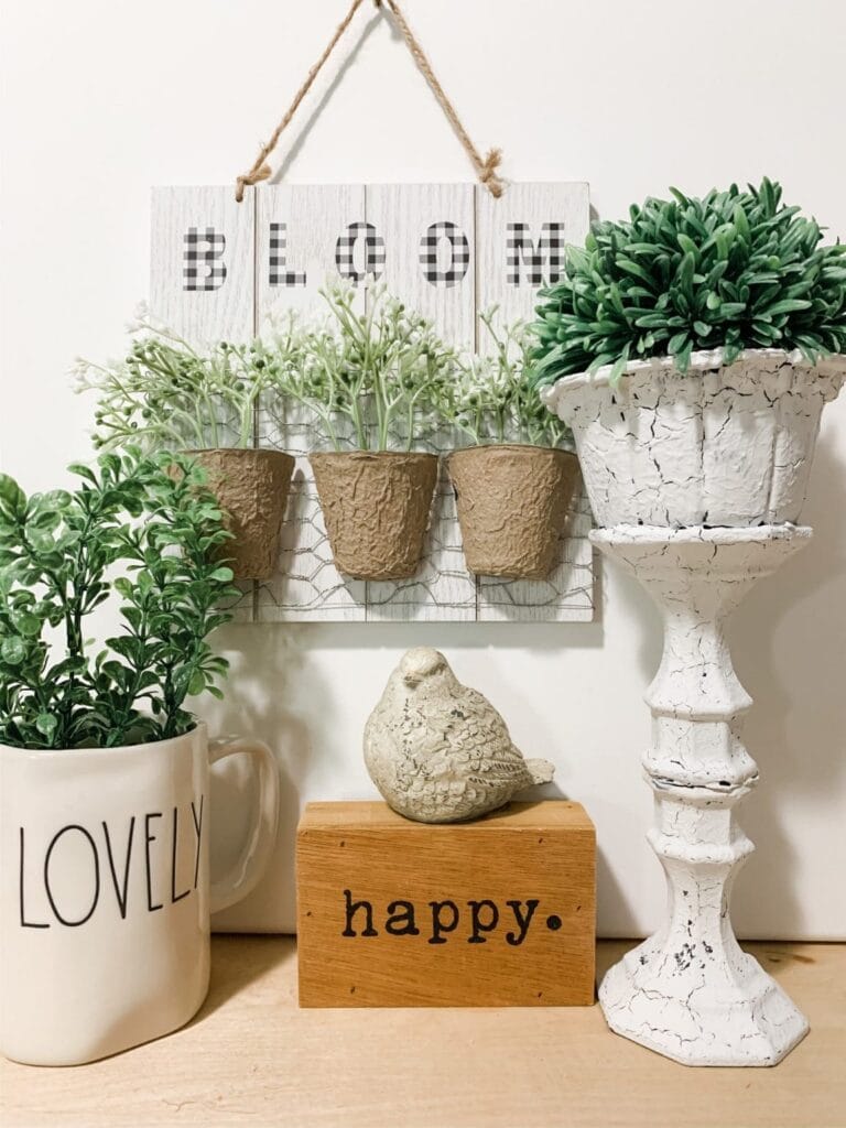 : “DIY floating wooden shelves and painted mason jars used as farmhouse kitchen décor on a budget.”