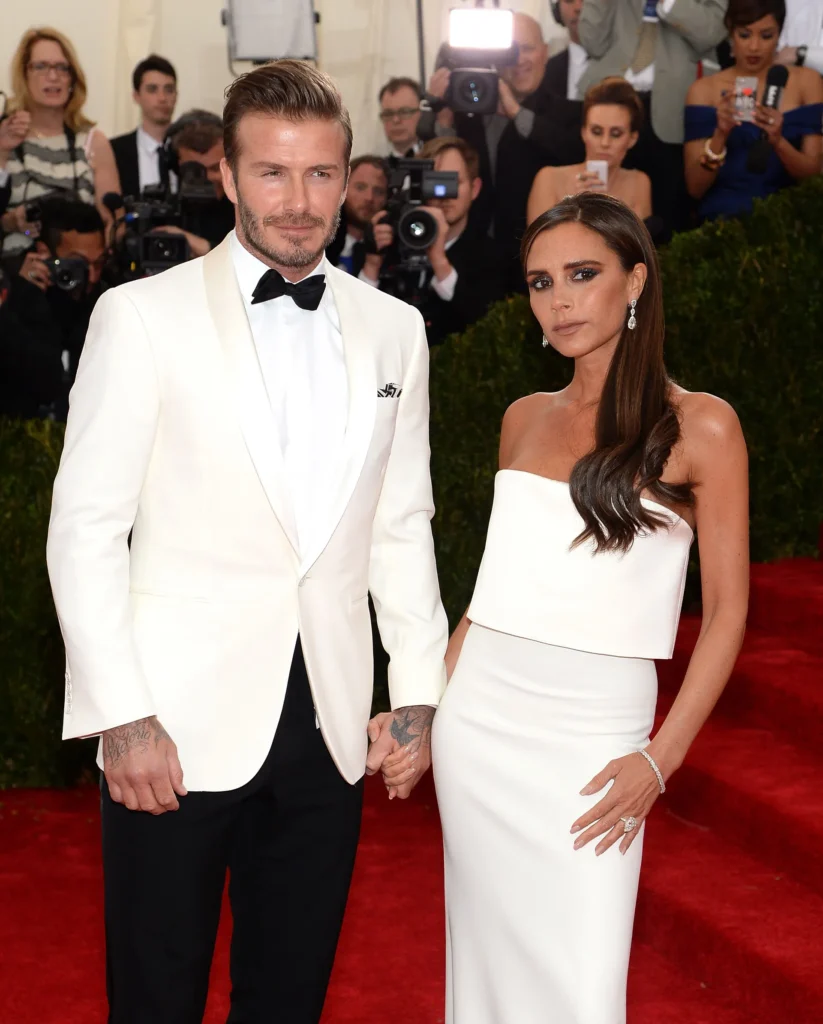 “David and Victoria Beckham posing elegantly at a fashion gala, symbolizing their strong marriage and public partnership.”