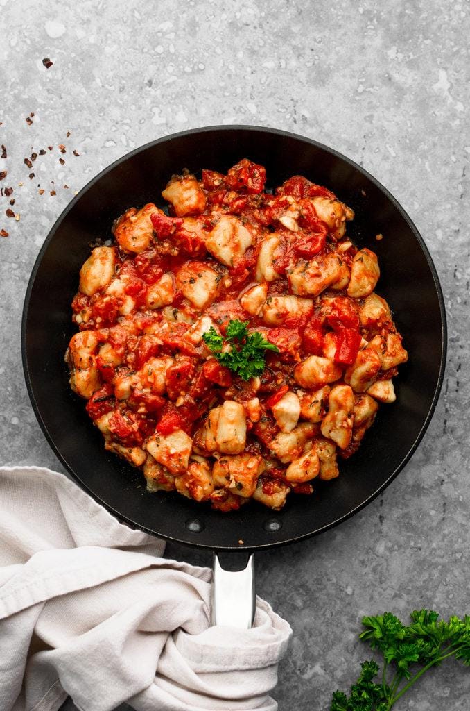 “Soft potato gnocchi served with rich tomato sauce and Parmesan – comforting Italian pasta dish perfect for home cooking.”
