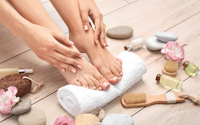 “Applying moisturizing cream to hands and feet as part of a post-shower care routine.”