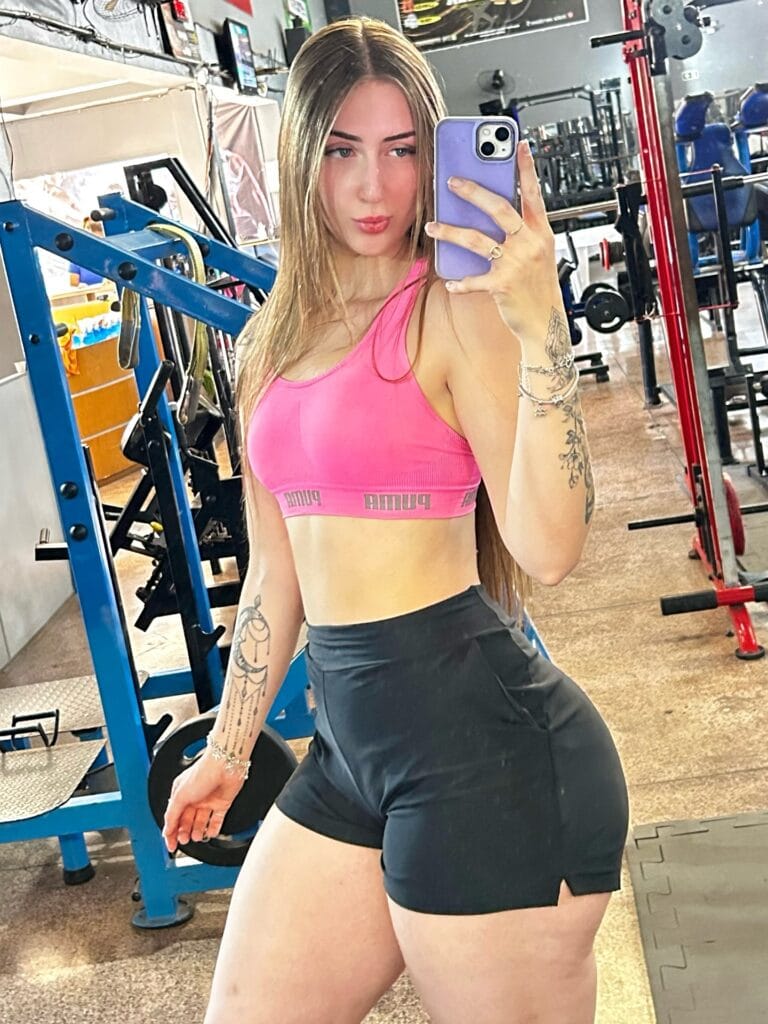 “Woman wearing cropped gym hoodie for warm-up.”