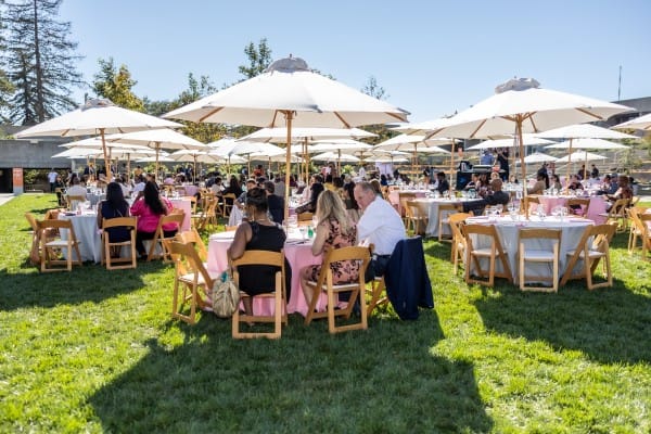 “Crew setting up lighting towers, sound systems, and portable restrooms for an outdoor event.”