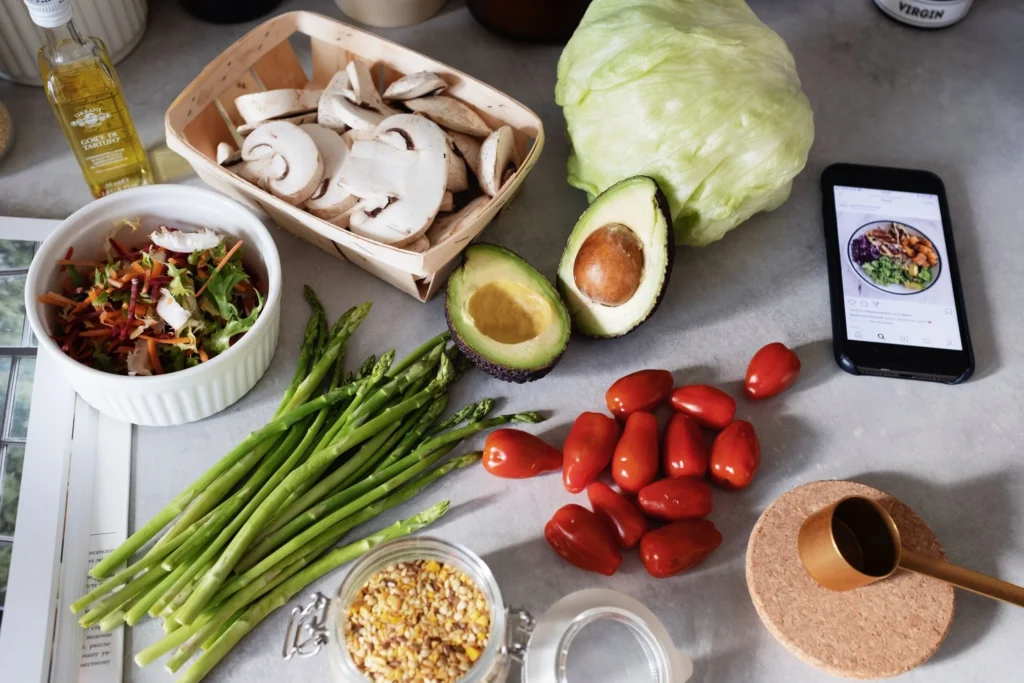 Flat lay of healthy soup ingredients like lentils, leafy greens, spices, and broth options.