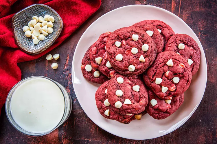 “Chewy red velvet cookies with white chocolate chips arranged on a baking tray for Valentine’s Day”