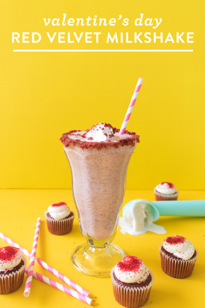 “Red velvet milkshake topped with whipped cream and heart sprinkles in a glass for Valentine’s Day treat”