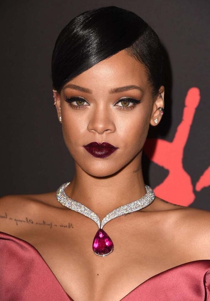 “Rihanna wearing emerald and diamond Chopard jewelry at Cannes Film Festival.”