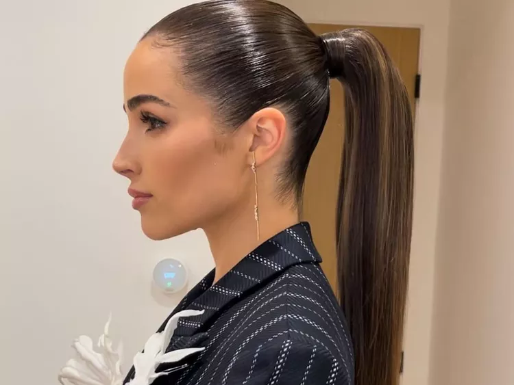 Sleek, slicked-back ponytail with a glossy finish perfect for humid summer evenings — Best Hairstyles to Beat Summer Humidity.