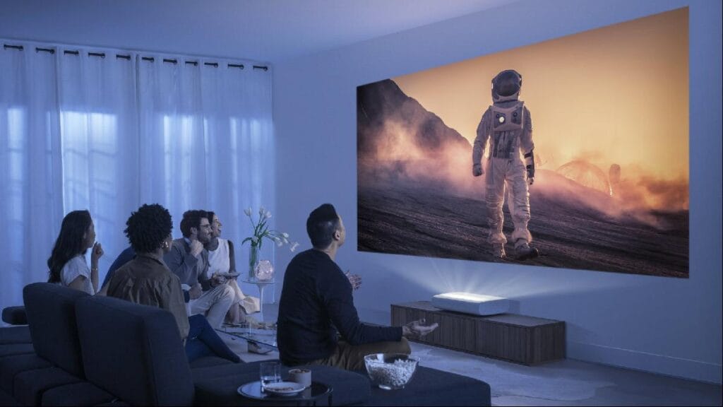 “Projector setup with a large screen and surround sound system for home movie night.”