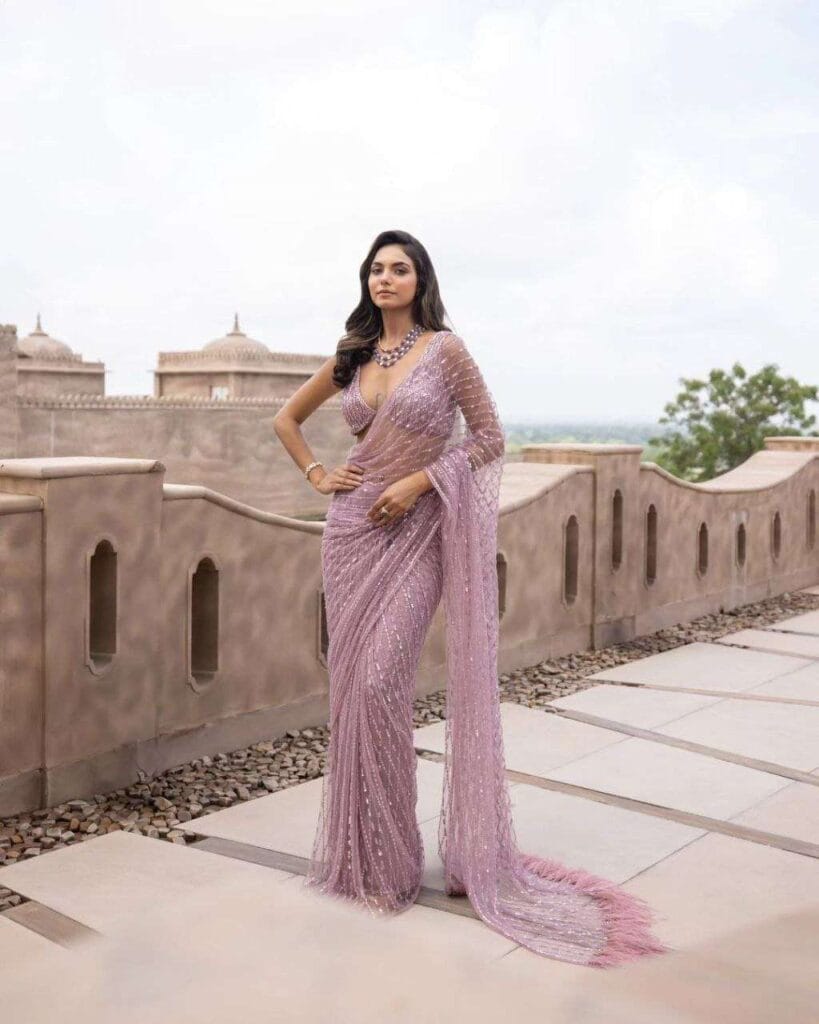 Glamorous sari with butterfly pallu drape exposing the midriff, ideal for red carpet or evening gala events.