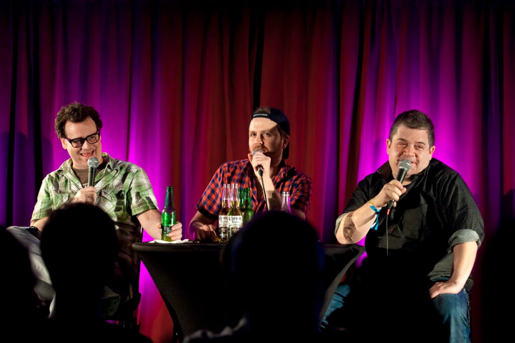 “Hosts Dave Anthony and Gareth Reynolds recording The Dollop comedy history podcast.”