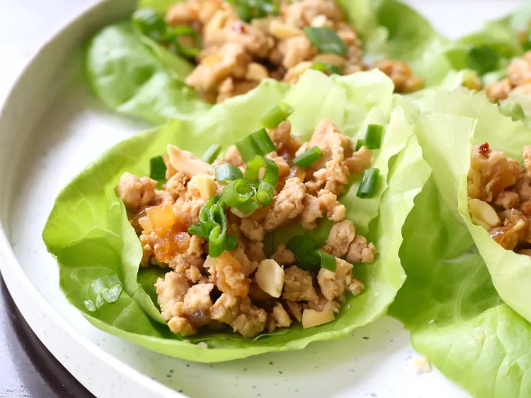 “Fresh lettuce wraps filled with ground turkey and garnished with chopped green onions.”