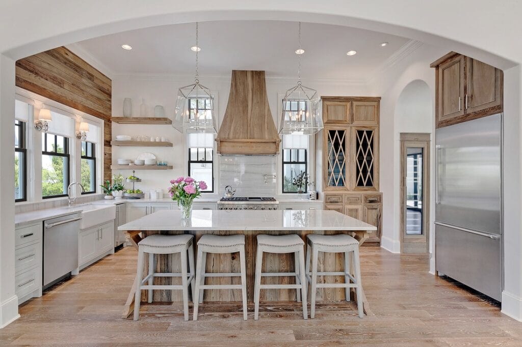 “Modern farmhouse kitchen with shiplap walls, exposed wood beams, and open shelving showcasing ceramic dishes.”