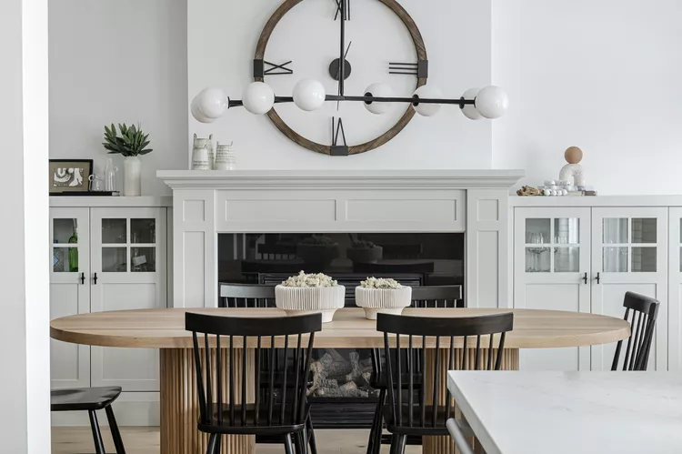 “Farmhouse kitchen wall with wooden signs, shiplap, and vintage clock adding rustic charm.”