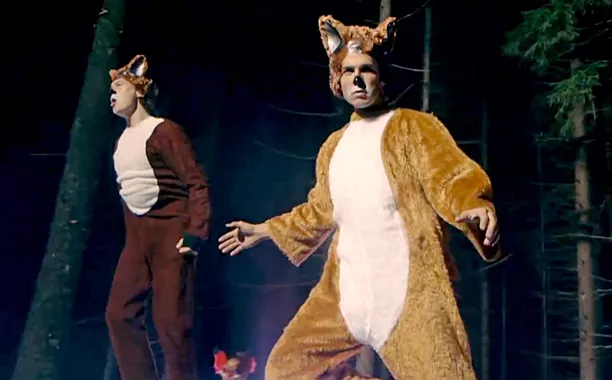 “The Ylvis duo performing ‘What Does the Fox Say,’ with colorful costumes and animal masks from the viral video.”