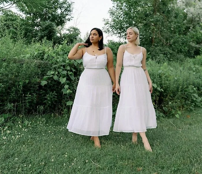 Maria Castellanos and Denise Mercedes posing together in matching outfits to promote the Style Not Size body-positivity movement.