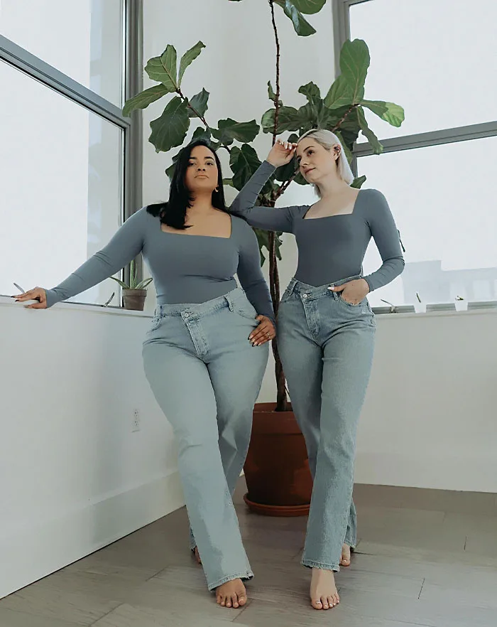 Inclusive fashion designer Mallorie Dunn posing in her design studio while speaking about the origins of the body positivity movement.