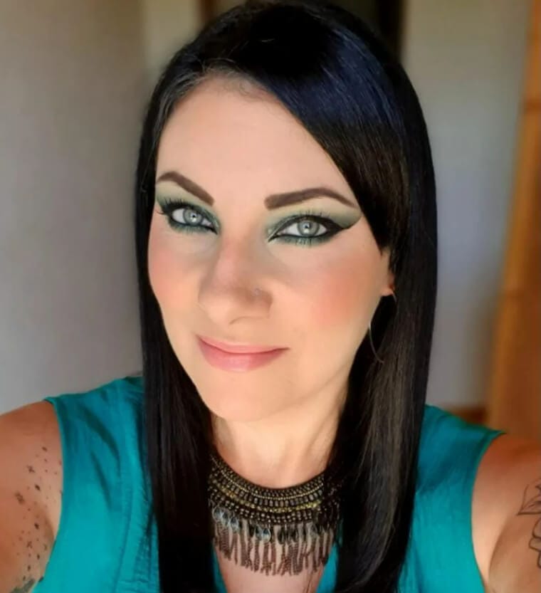 Woman with heavy eye makeup showing dark eyeshadow and thick eyeliner that makes her look older.