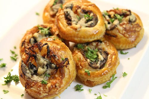 “Puff pastry tartlets topped with caramelized onions and melted Gruyère cheese.”