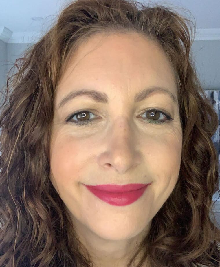 Lipstick being applied after foundation, showing the final touch of a complete makeup look.