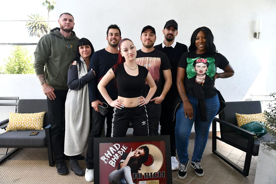 Danielle Bregoli posing with her management team during an industry event, showcasing her rise from meme to mainstream artist.