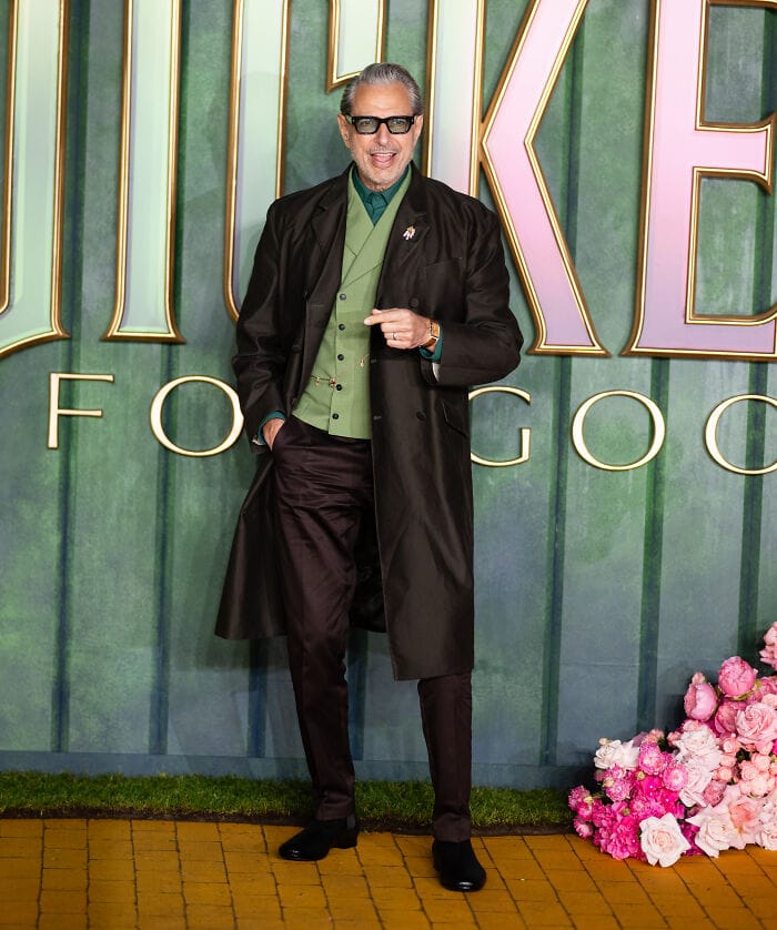 Jeff Goldblum in emerald green Wizard-inspired outfit and brown trench coat on the Wicked: For Good London red carpet.
