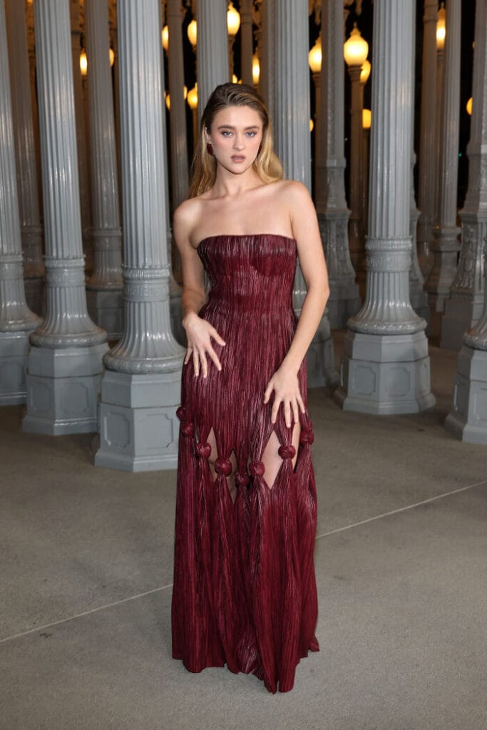 Lizzy Greene steps out in a unique wine-red leather Cult Gaia dress with thigh cutouts at the 2025 LACMA Gala.