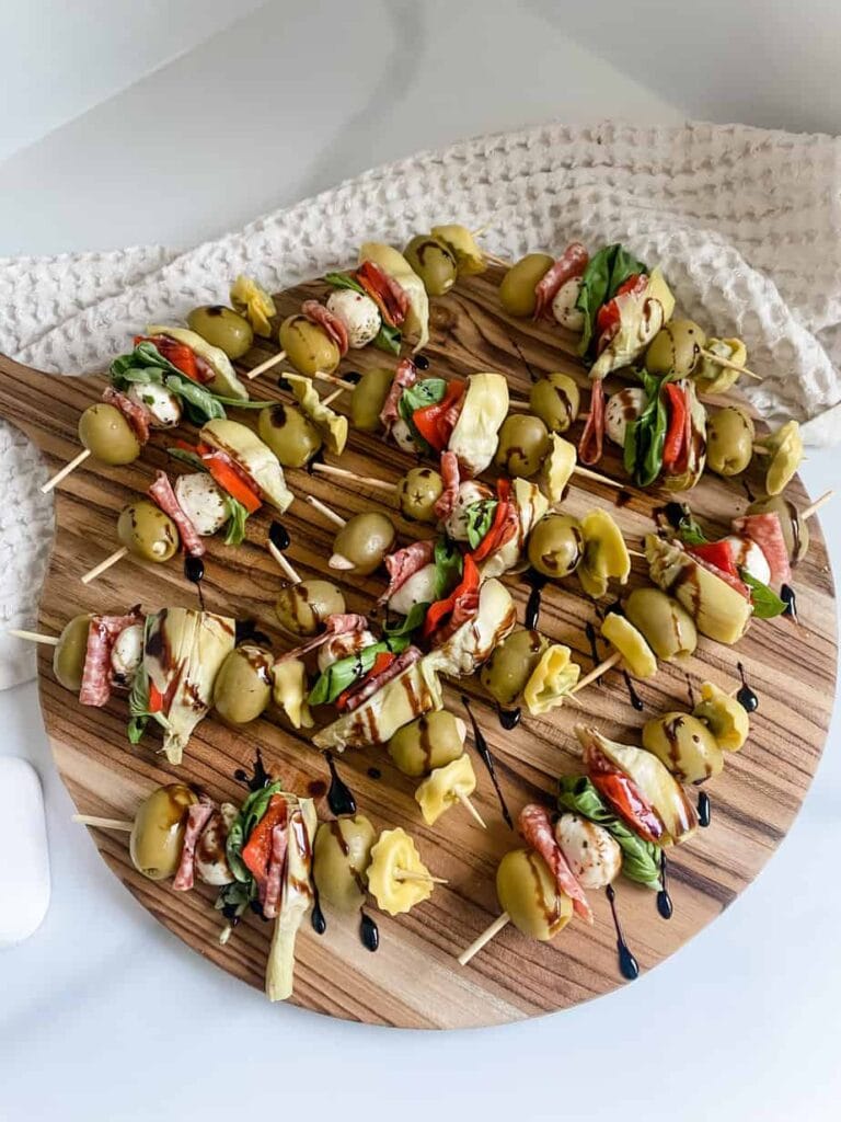“Colorful mini cheese and charcuterie skewers served on a party platter for New Year’s Eve.”