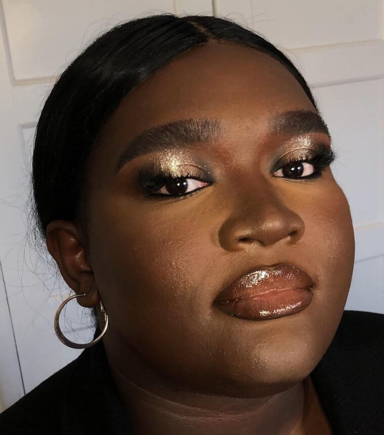 Subtle shimmer highlighter applied on cheekbones for a soft glow without over-shine.