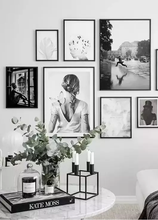 “Black and white framed photography art arranged in a modern living room”
