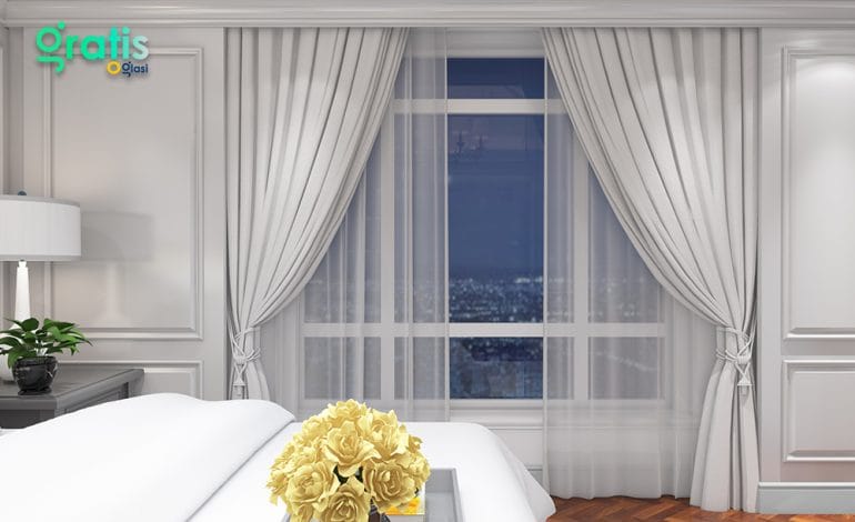 Double rod curtains with layered fabrics creating depth in a modern home interior.