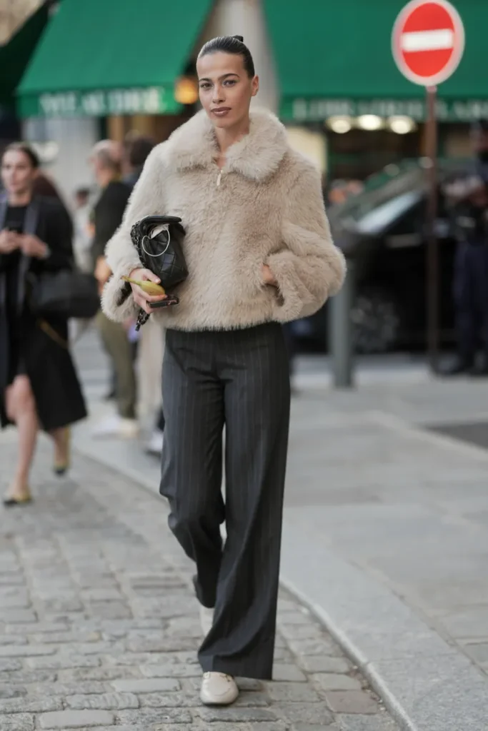 “Faux fur jacket worn as a statement winter coat for a chic December street style look.”