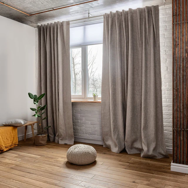 Floor-to-ceiling curtains creating a tall and elegant look in a modern living room.