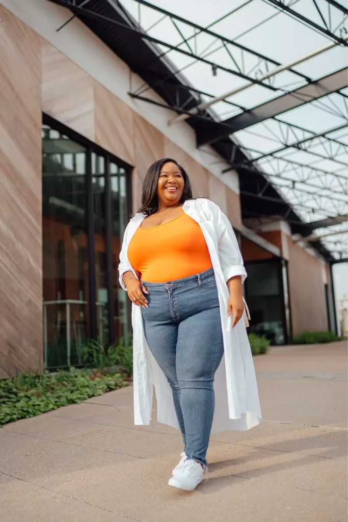 Plus size woman wearing high-waisted jeans paired with a casual top