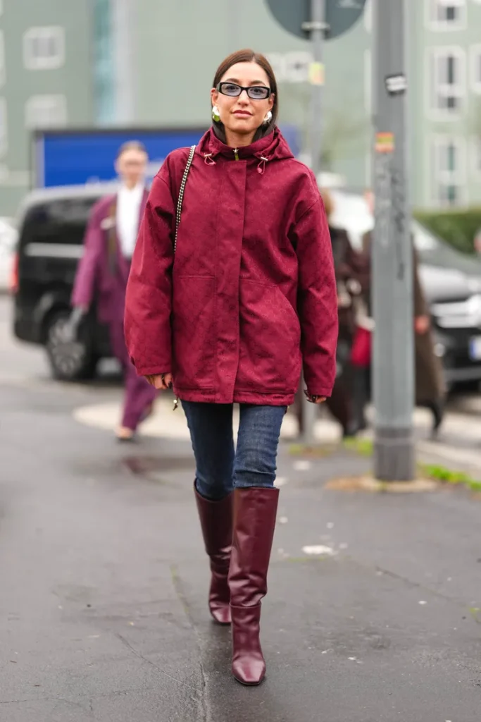 “Knee-high boots styled with a chunky sweater and skinny jeans for a cozy winter outfit.”