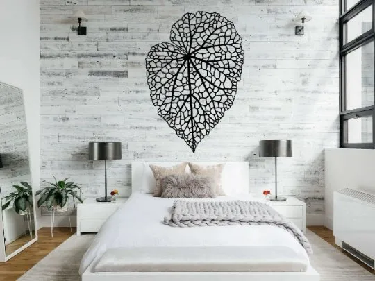 “Modern geometric metal wall art installed on a living room accent wall”