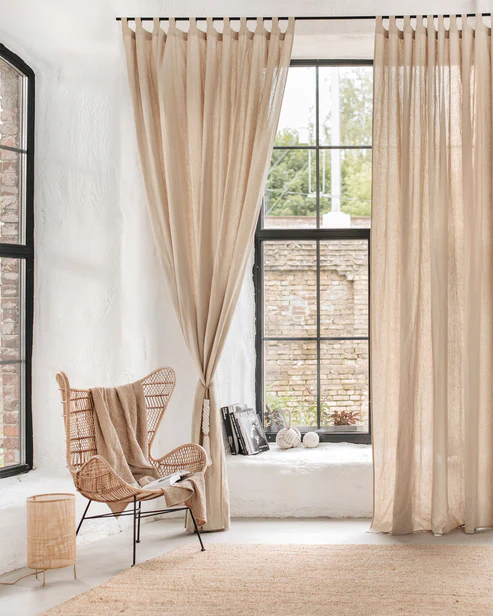 Neutral linen curtains bringing a soft, natural feel to a modern living room.